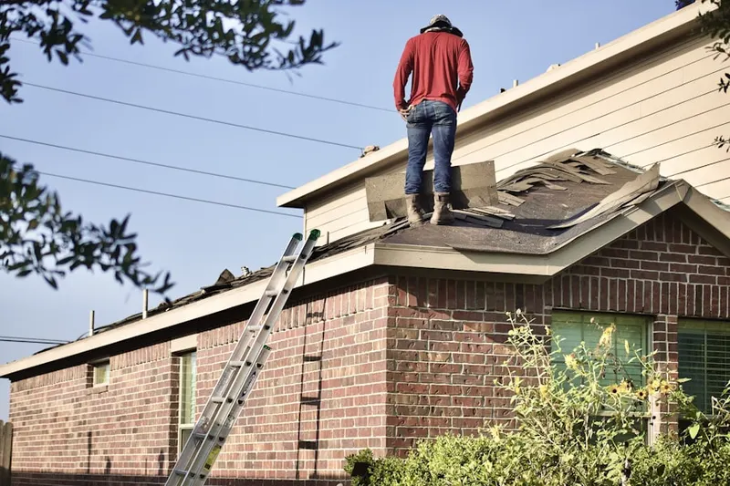 Professional roofer working on a residential roof in Peachtree Gardens